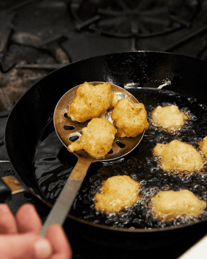 Fritelle di baccala in a pan with oil