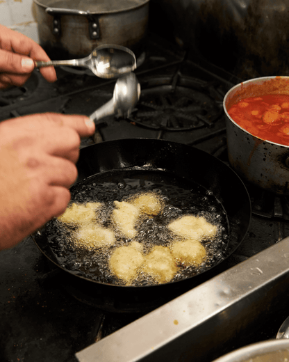 Fritelle di baccala in a pan with hot oil