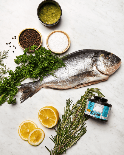 White fish with herbs and spices, lemon and klishi spice. 